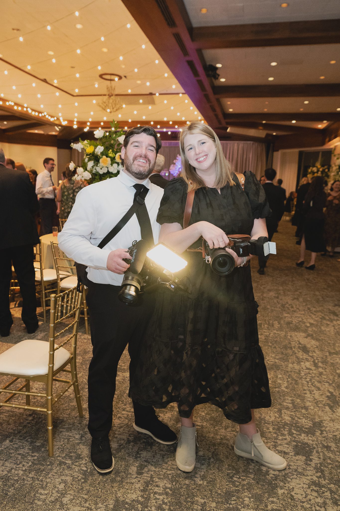 Husband and wife Birmingham Alabama wedding photographer and videographer team at wedding reception