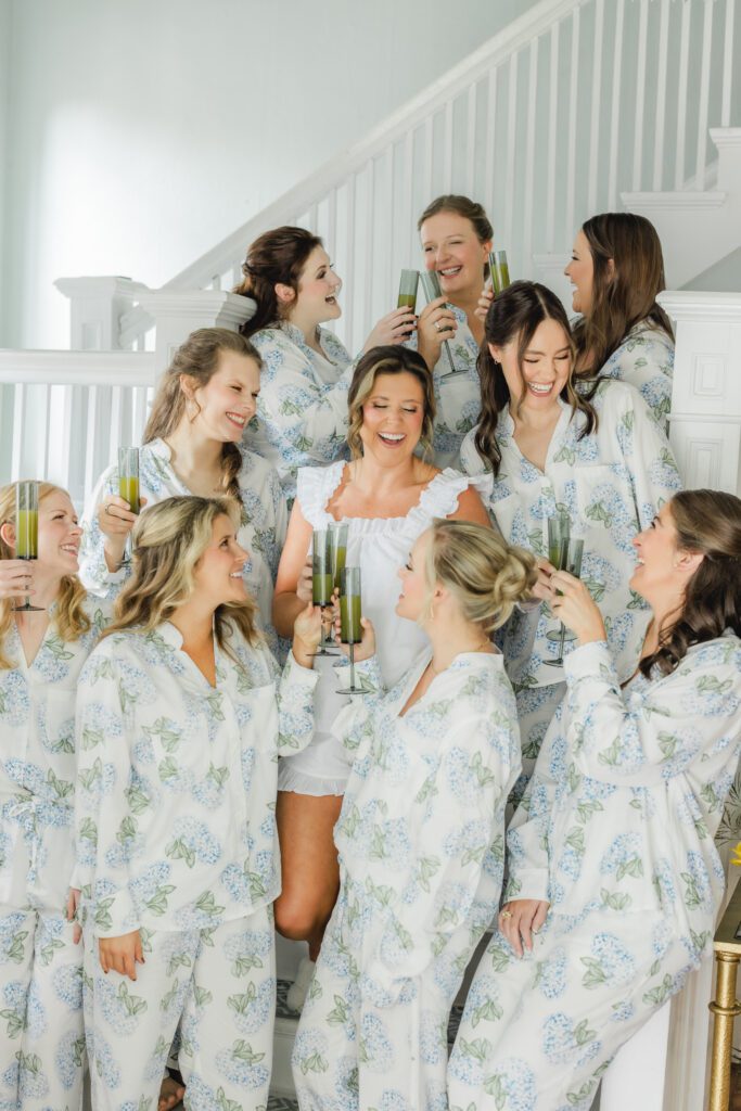 Bride getting ready with bridesmaids for her wedding day in Birmingham Alabama with champagne