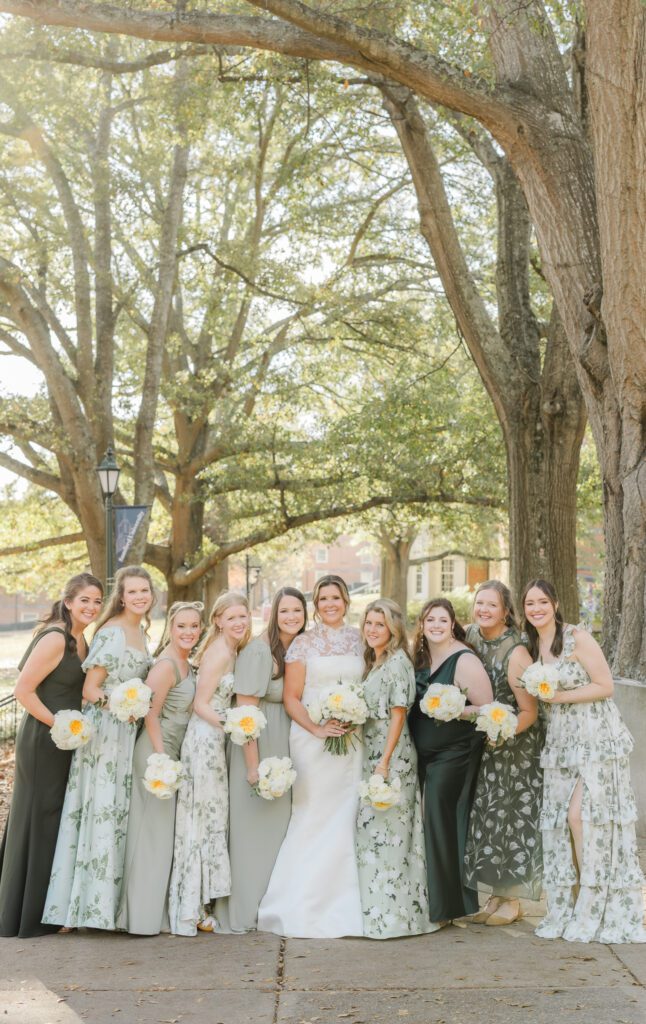 Bridesmaids posing together for wedding photos in Birmingham Alabama with elegant garden party style