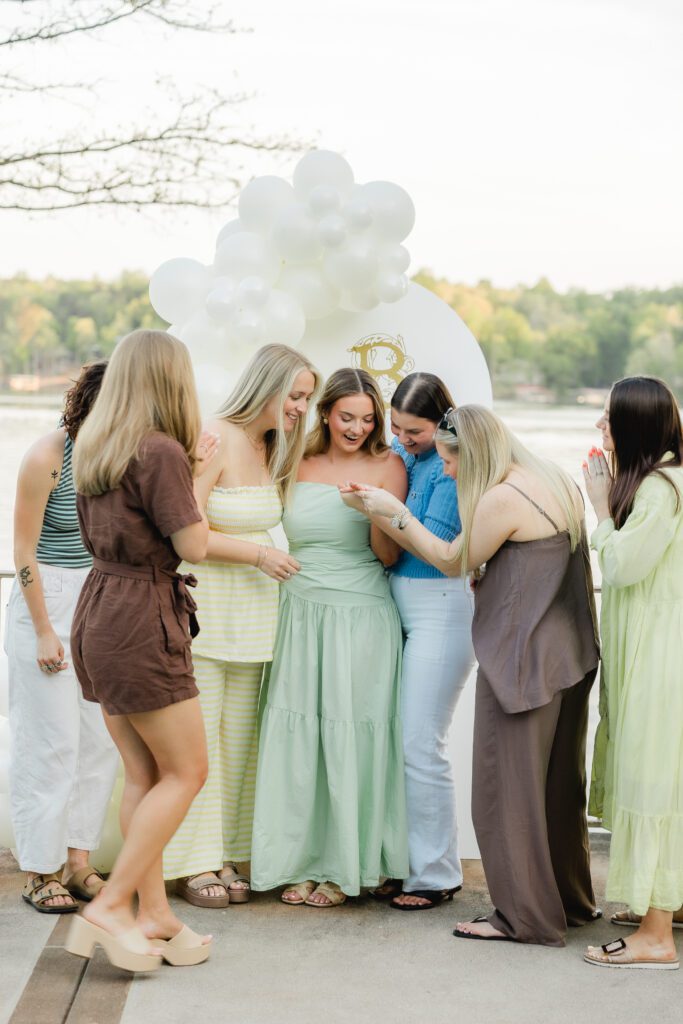 friends and family celebrating engagement at Smith Lake Alabama lake house