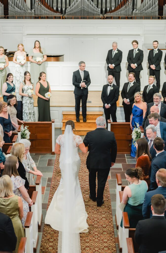 Wedding ceremony at Reid Chapel in Birmingham Alabama with bride walking down the aisle
