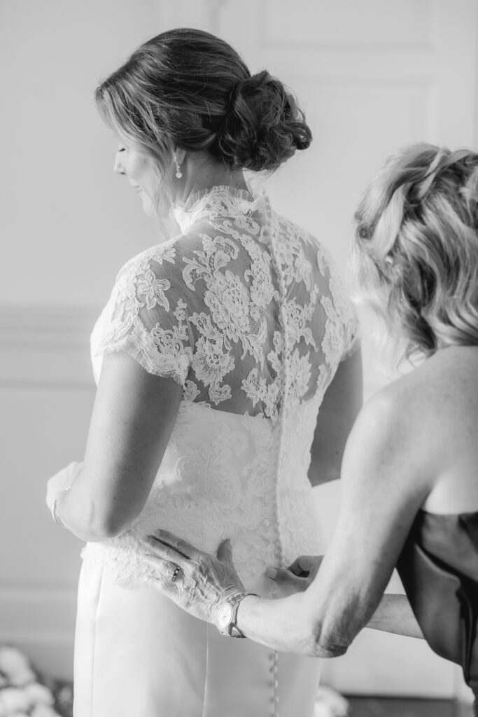 Bride getting ready with mother for her wedding day in Birmingham Alabama with elegant details and natural light