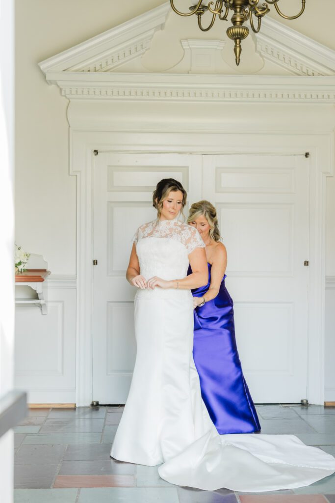 Bride getting ready with mother for her wedding day in Birmingham Alabama with elegant details and natural light