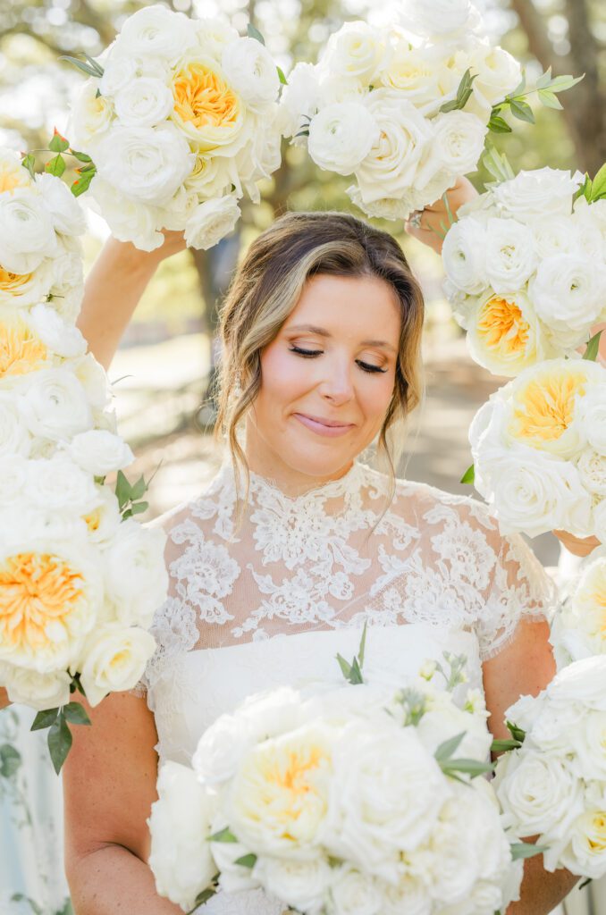 Bride posing for wedding photos in Birmingham Alabama with elegant garden party style