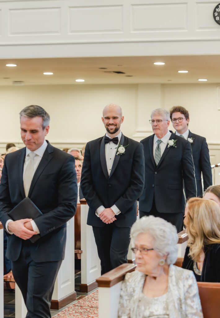 Wedding ceremony at Reid Chapel in Birmingham Alabama with groom walking down the aisle