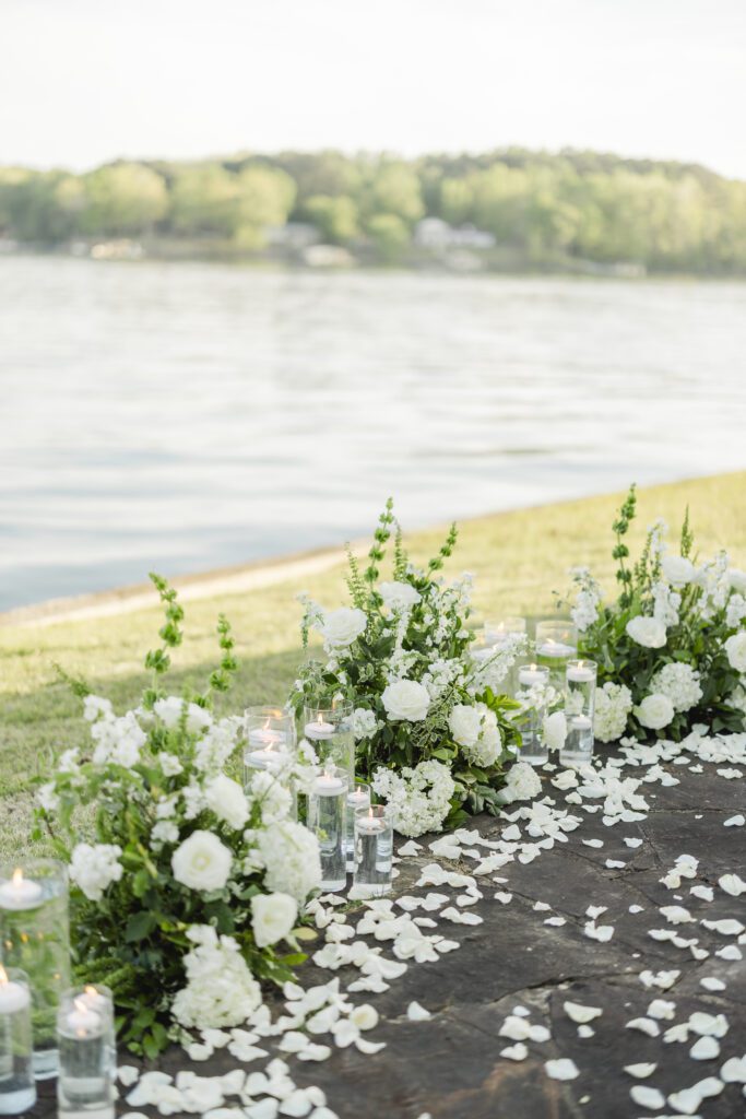 romantic proposal setup at Smith Lake Alabama with candles rose petals and champagne by the water