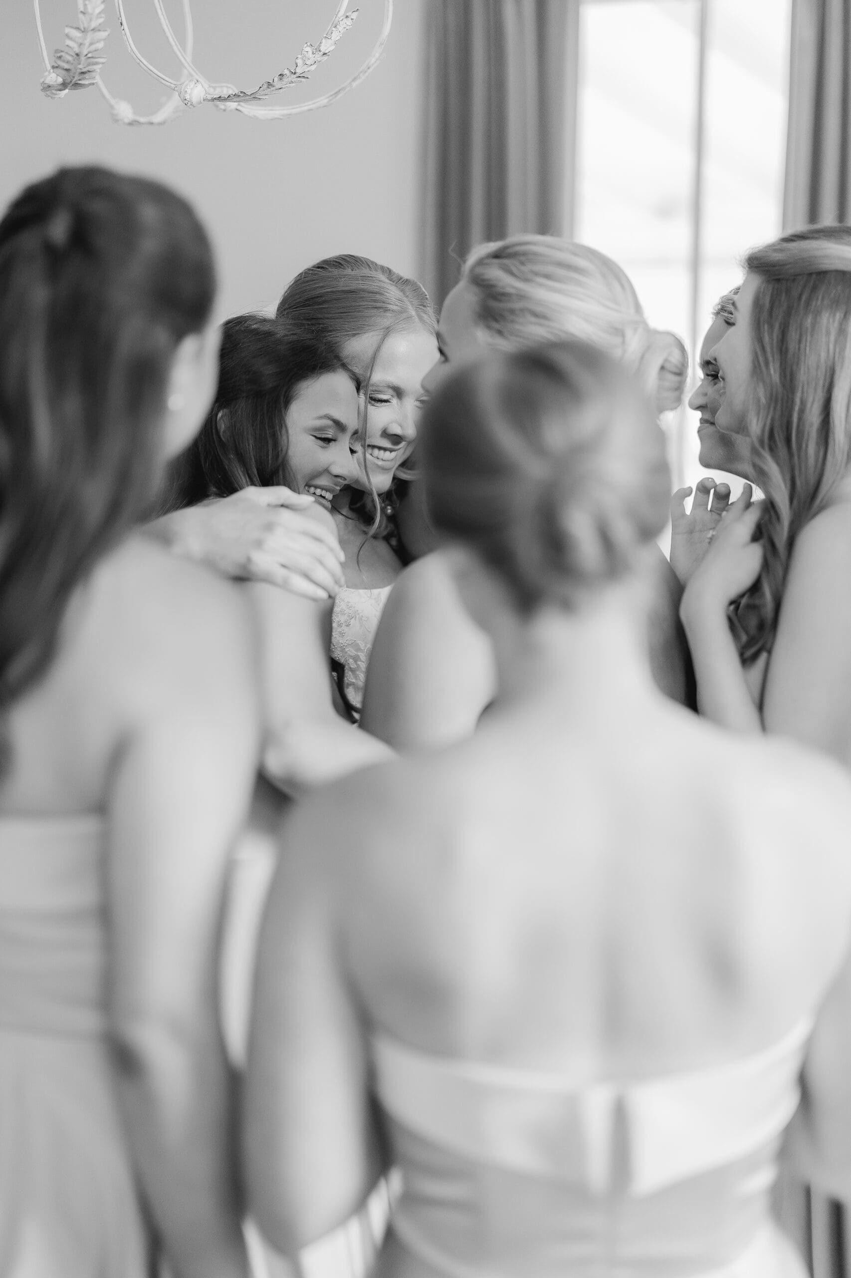 Bridesmaids reacting emotionally to bride’s wedding dress reveal