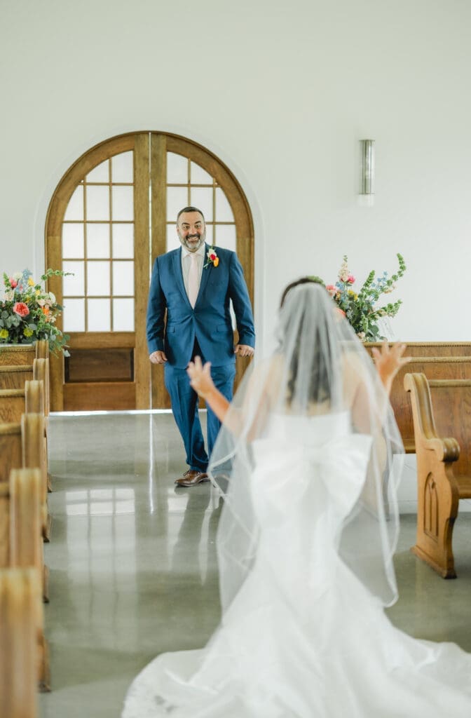 Bride sharing emotional first look with her father on wedding day