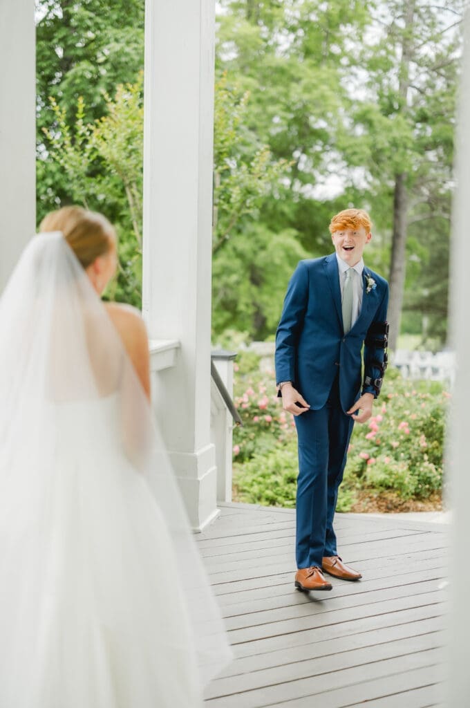 Bride sharing emotional first look with little brother before wedding