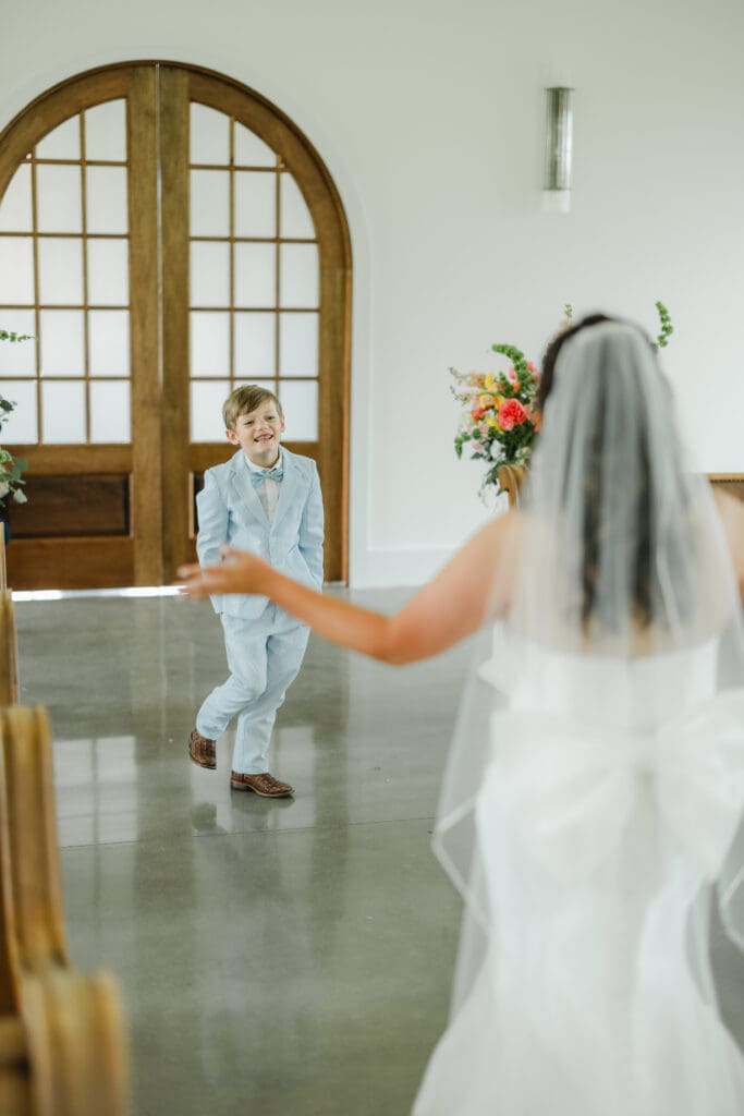 Sweet first look moment between bride and young family member