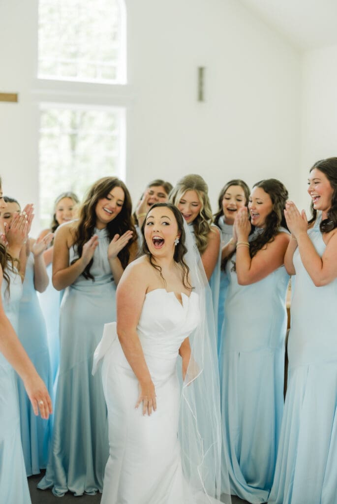 Bridesmaids first look with bride wearing blue dresses at Alabama wedding