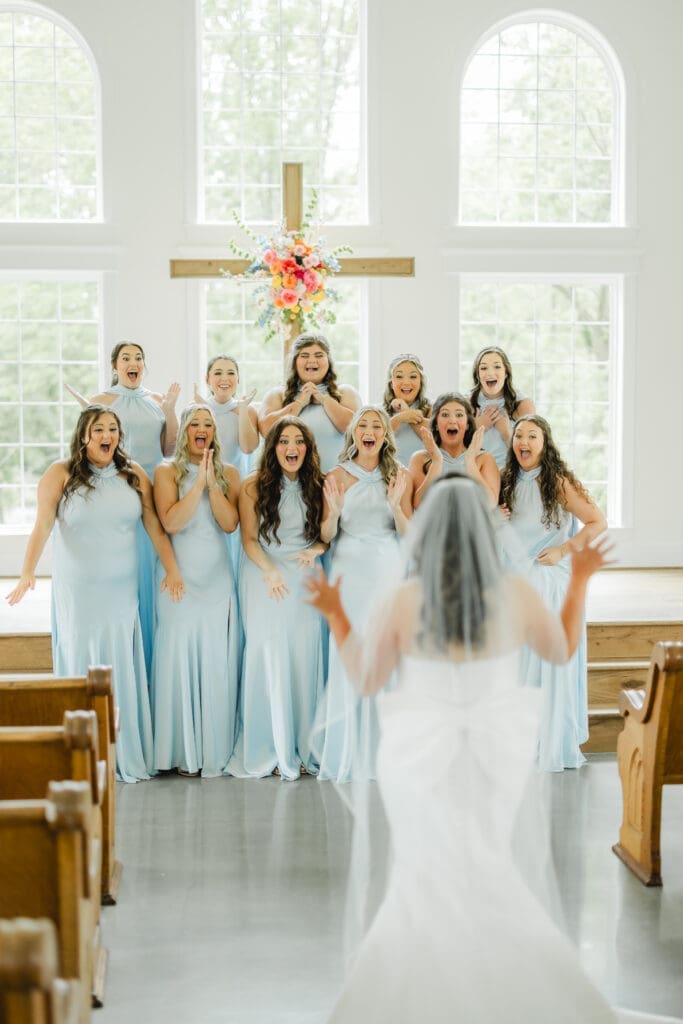 Bridesmaids first look with bride wearing blue dresses at Alabama wedding