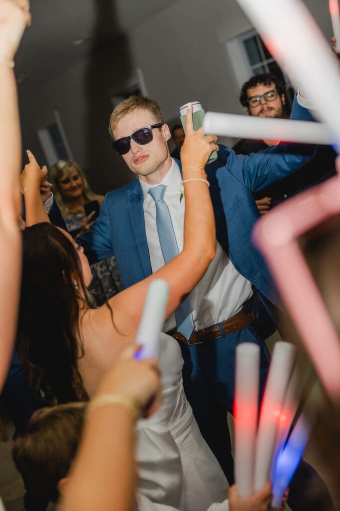Guests celebrating on dance floor at joyful wedding reception