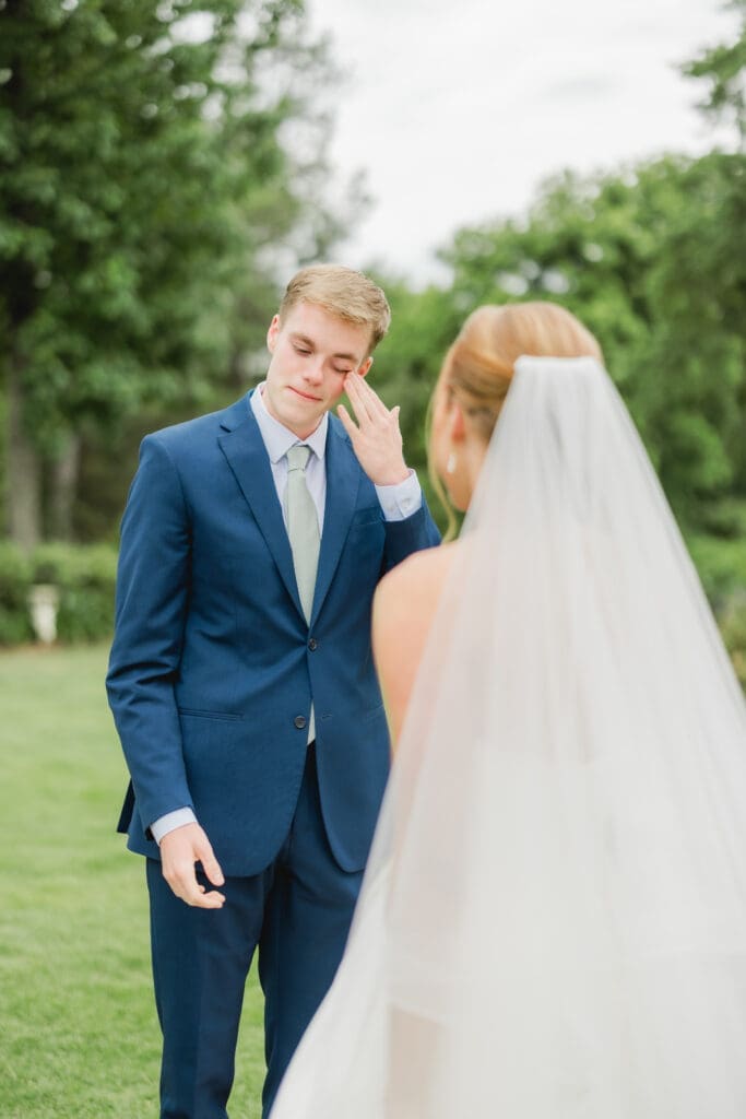 Groom emotional reaction during first look with bride