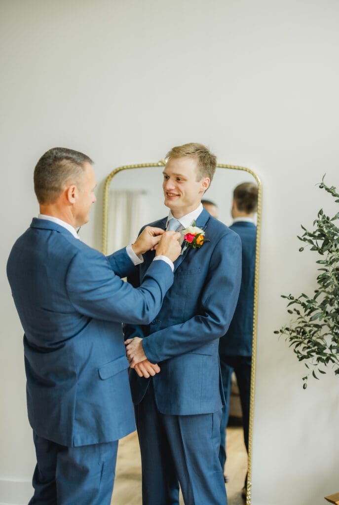Groom getting ready with dad before Hoyt Hollow wedding ceremony