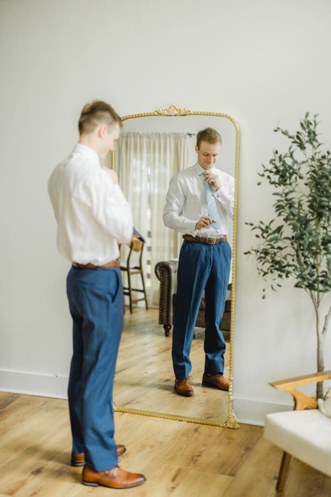Groom getting ready before Hoyt Hollow wedding ceremony