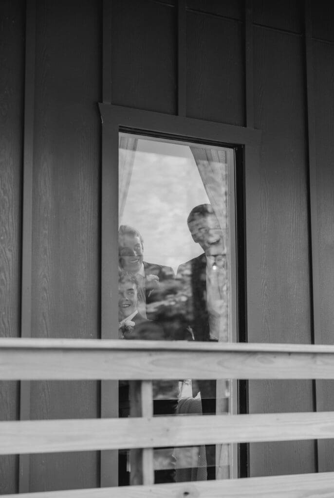 Emotional first look between bride and groom with groomsmen at Hoyt Hollow wedding