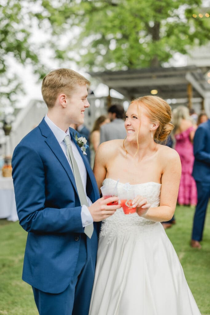 Couple celebrating with unique lemonade bar during Birmingham wedding cocktail hour
