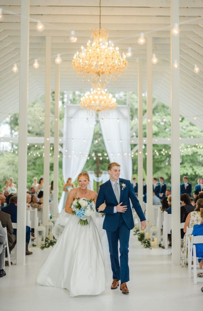 Bride and groom joyful recessional after wedding ceremony