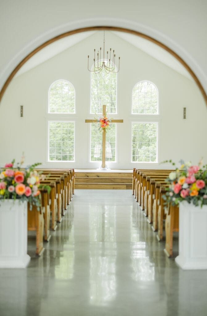 Wedding ceremony inside white chapel at Hoyt Hollow Alabama