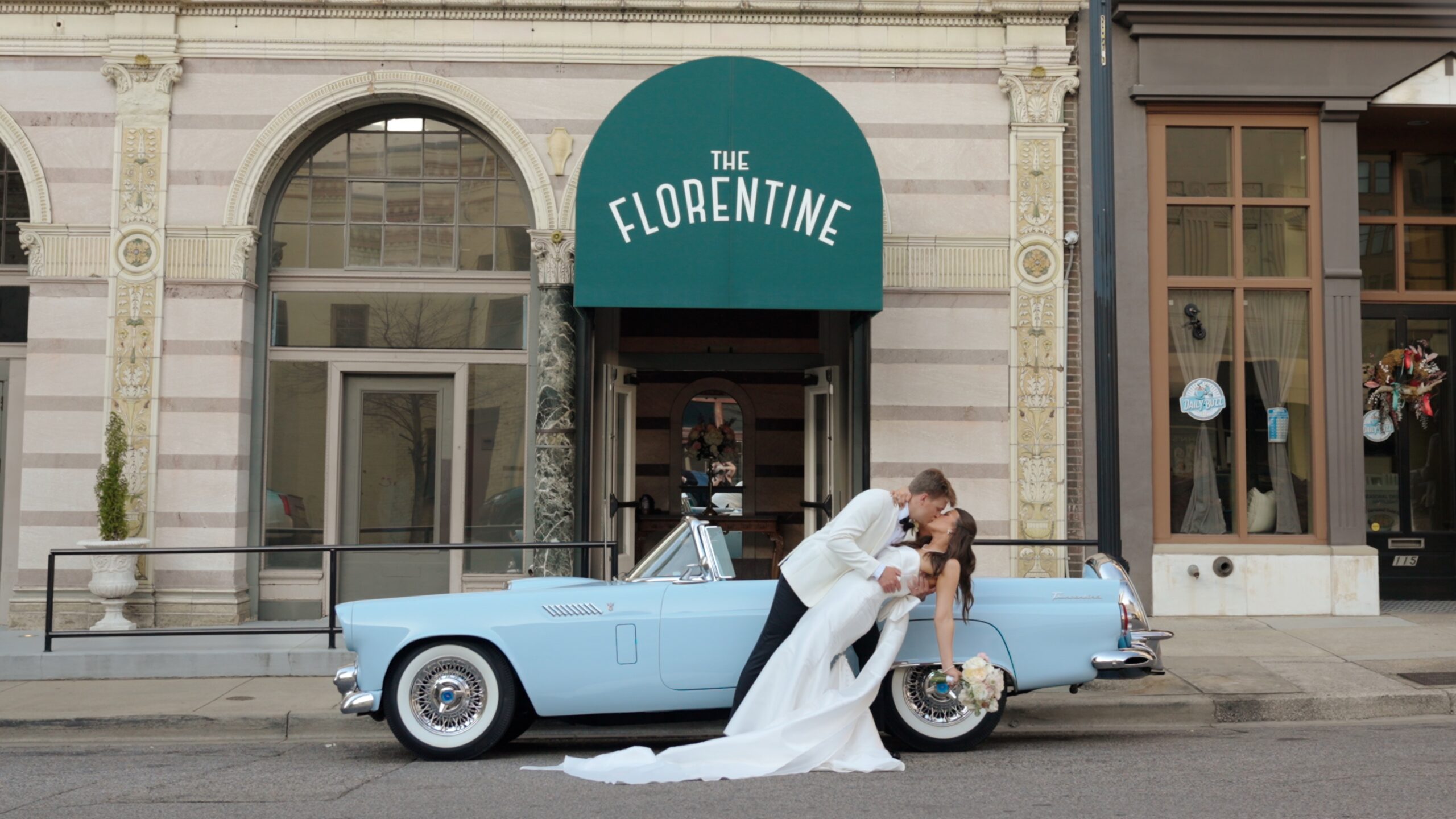 Bride and groom with vintage getaway car in Birmingham