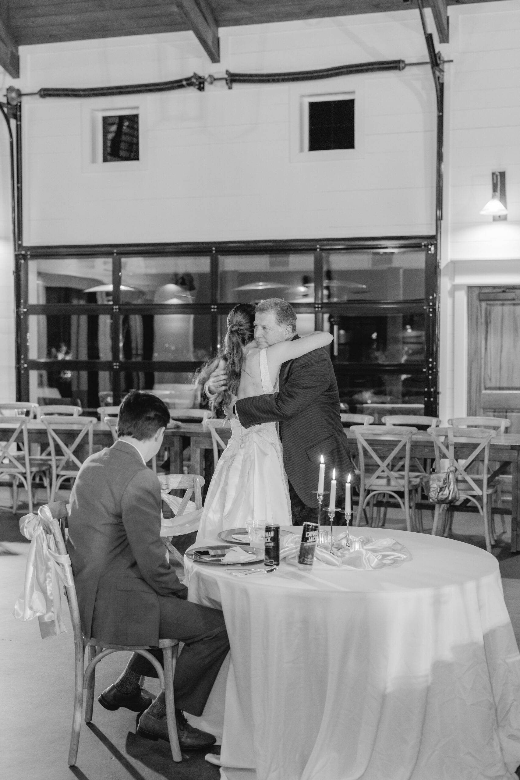 Family and loved ones sharing meaningful moments during Goodwin and Kaleb's wedding rehearsal dinner.