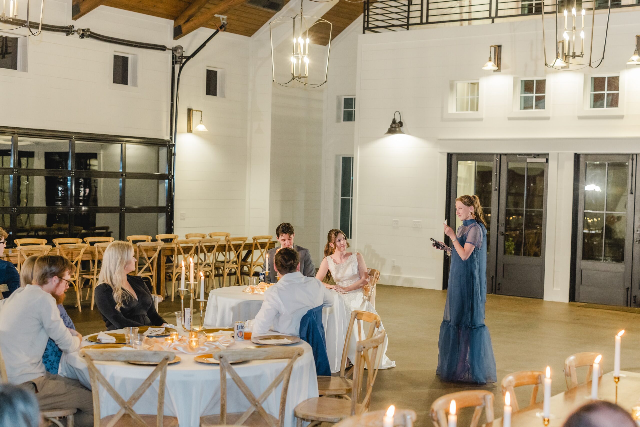 Friends and family sharing heartfelt stories and toasts during Goodwin and Kaleb's rehearsal dinner.