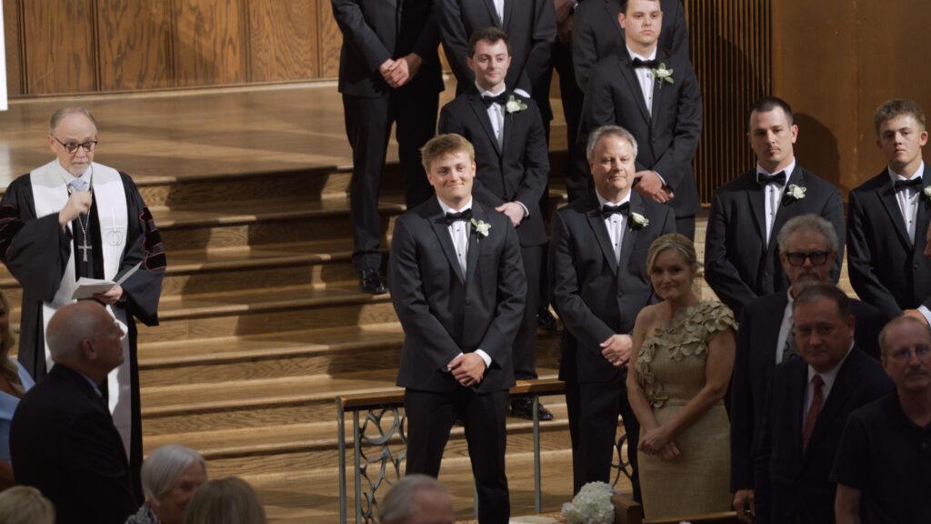 Groom reaction to bride walking down the aisle during Birmingham church wedding