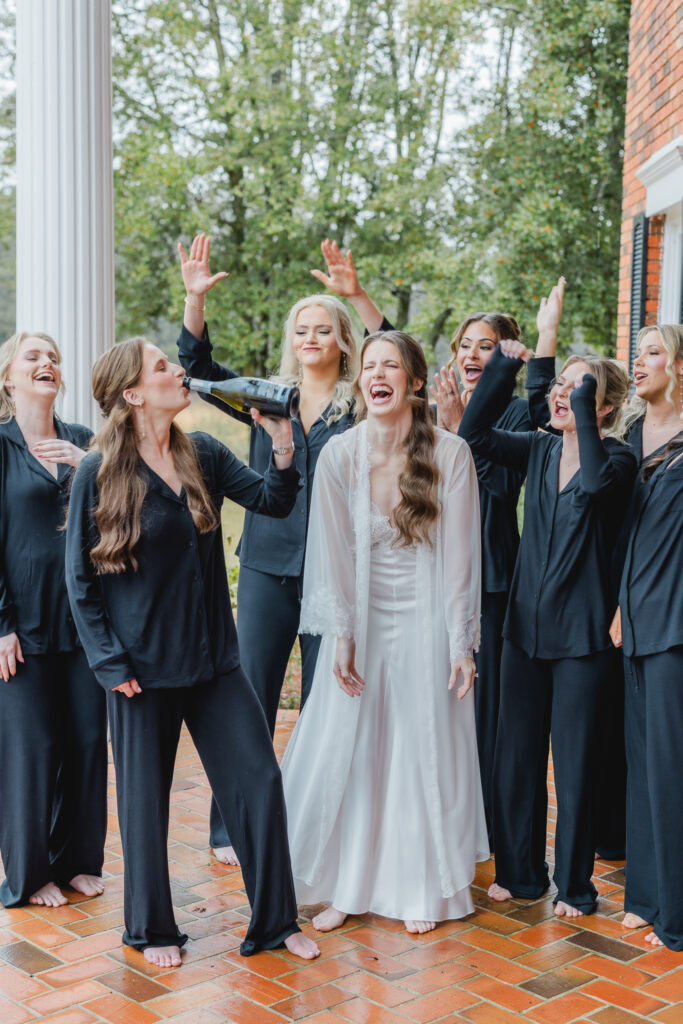 Bride sharing a joyful moment with her bridesmaids before the ceremony at Ridge Pointe.
