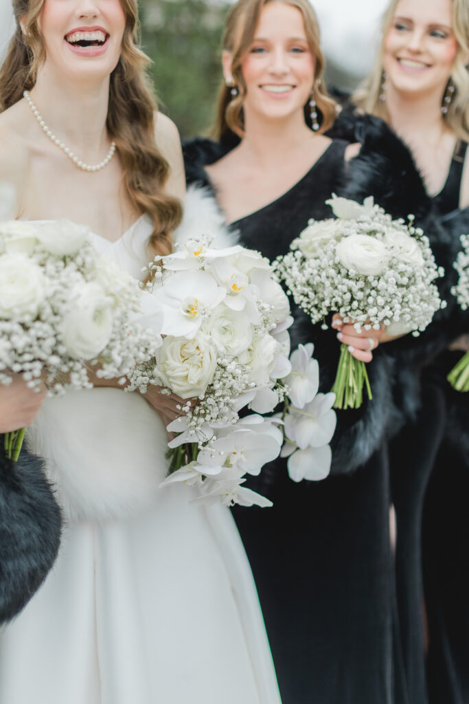 Bride celebrating with her bridesmaids with florals at Ridge Pointe.