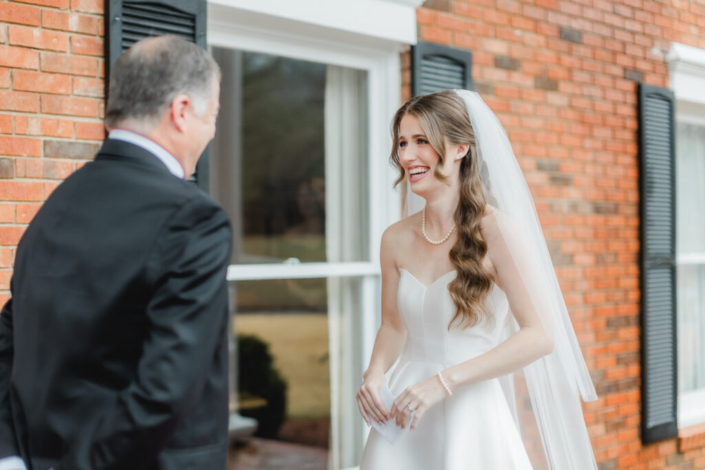 Emotional reactions during a first look with dad photographed by Birmingham wedding photographers.