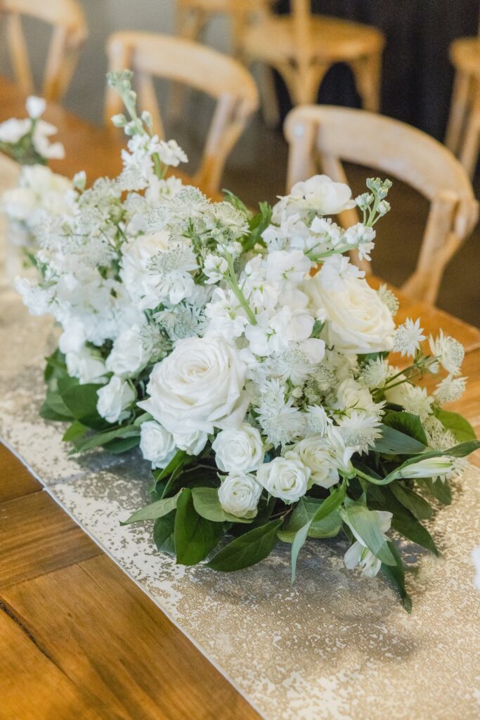 Beautiful reception table design featuring florals and candlelight at Ridge Pointe.
