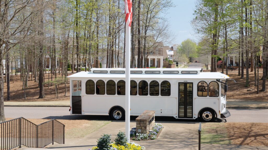 Wedding party cheering from vintage trolley during first look