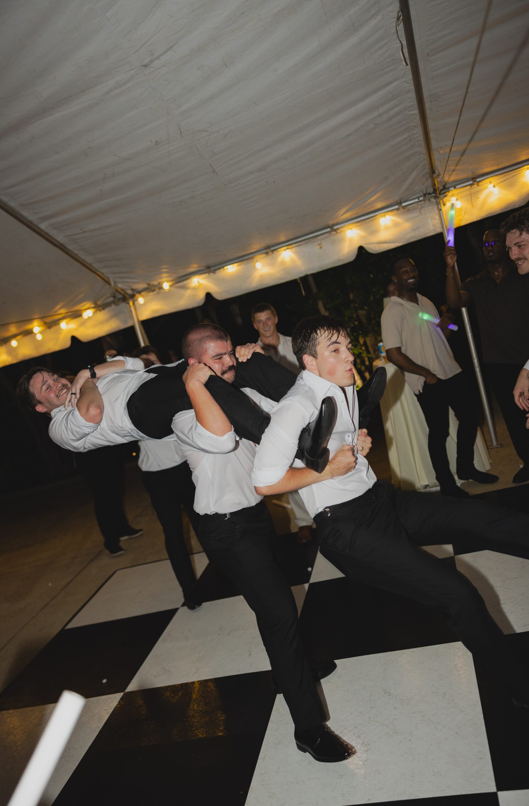 Kendall and Luke’s groomsmen performing a fun helicopter dance move during the wedding reception
