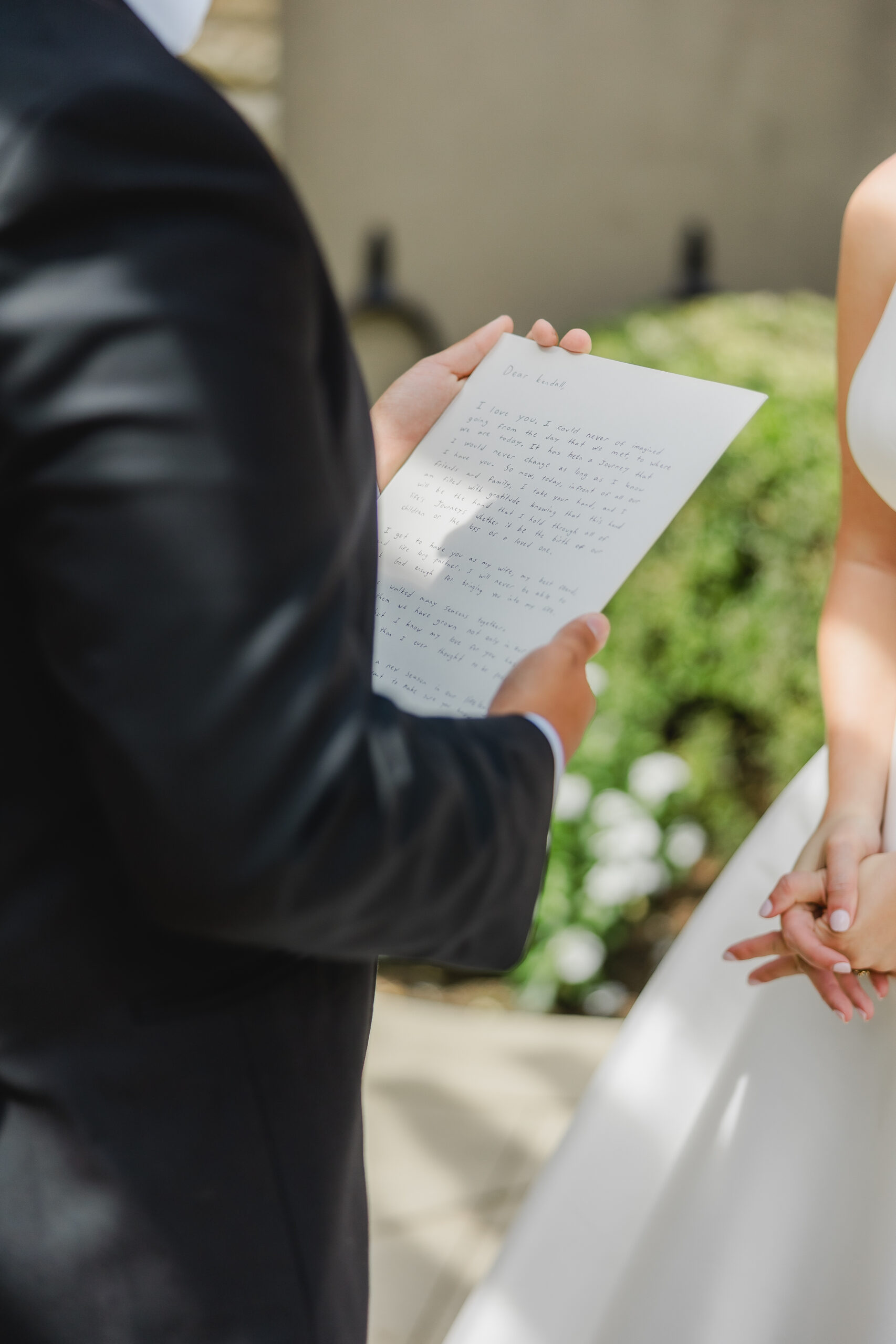 Kendall and Luke reading personal vows they wrote for each other before their Birmingham wedding ceremony