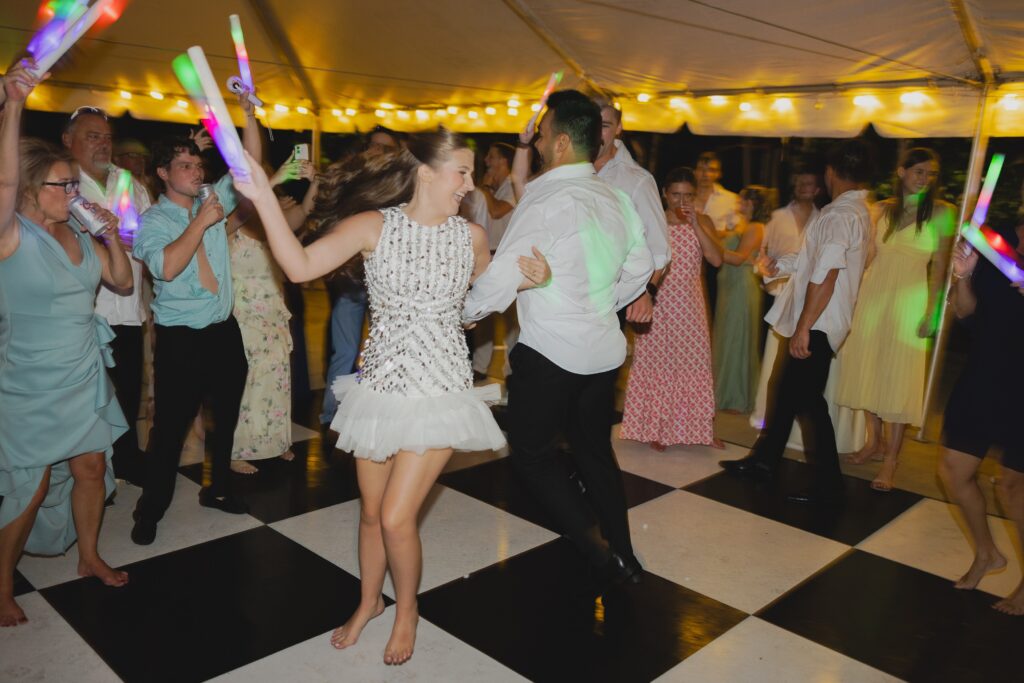 Kendall and Luke dancing with guests during their lively Clubhouse on Highland wedding reception
