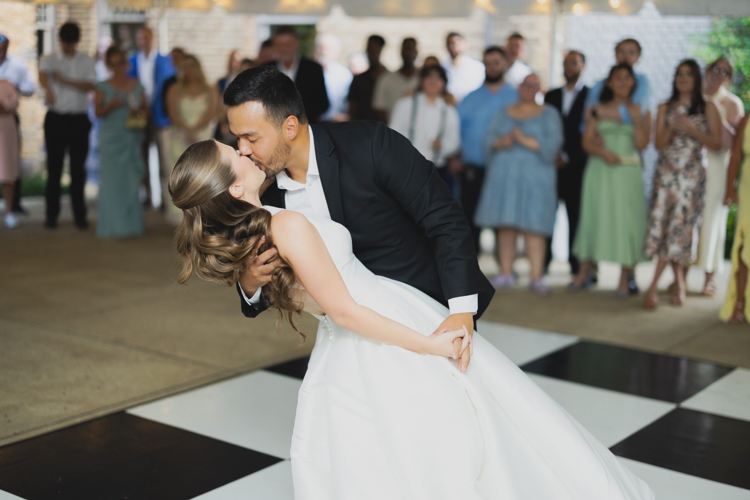 Kendall and Luke dancing with guests during their lively Clubhouse on Highland wedding reception