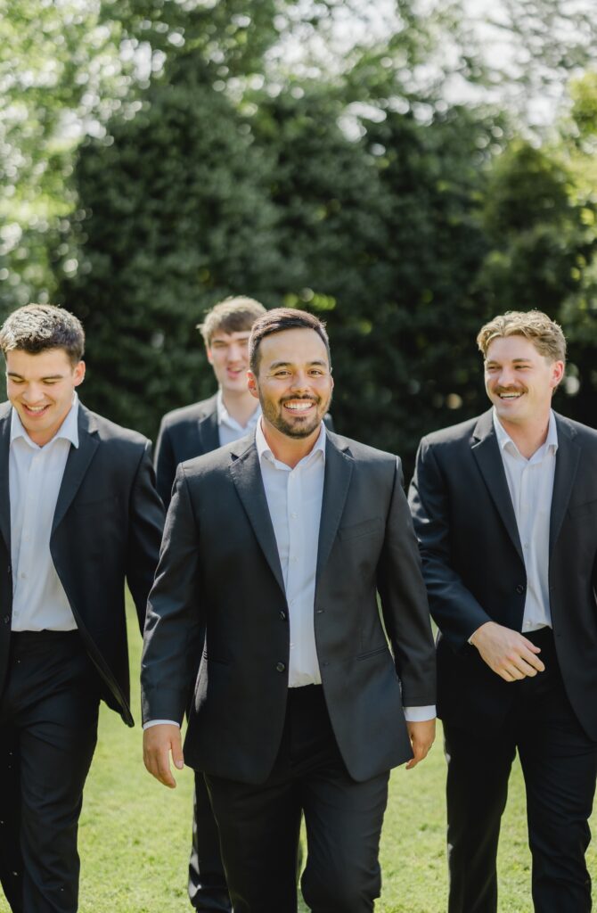 Luke posing with his groomsmen outside the chapel at Church of the Highlands Grants Mill