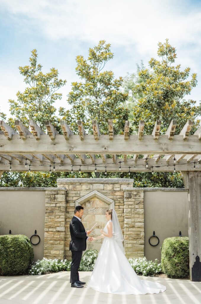 Kendall and Luke sharing private wedding vows in the courtyard at Church of the Highlands Grants Mill