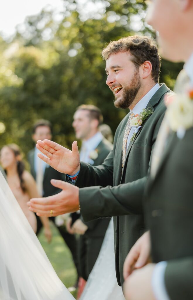 Groom and groomsmen celebrating before a wedding at The Barn at Smith Lake
