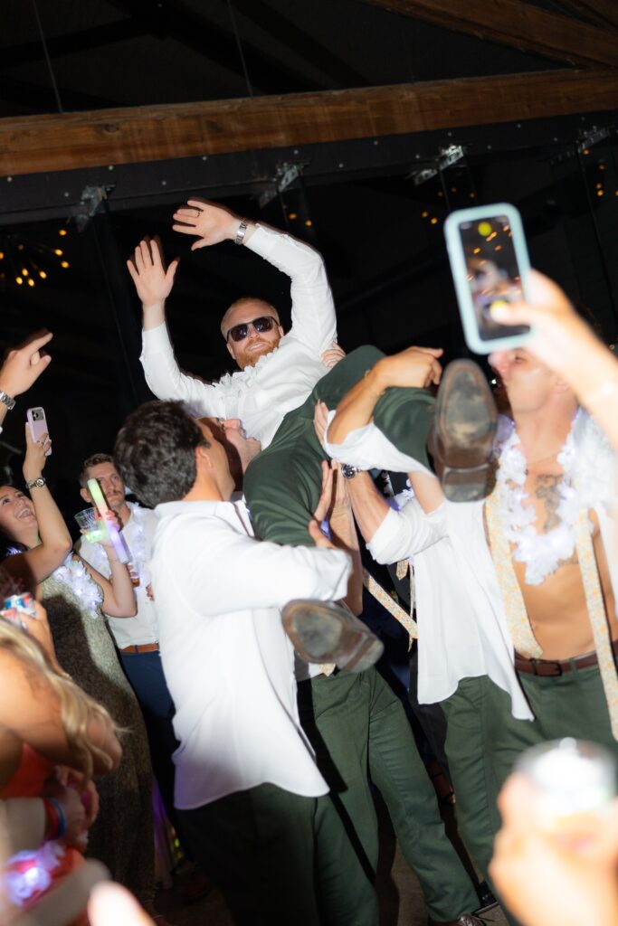 Jack being tossed in the air during wedding reception