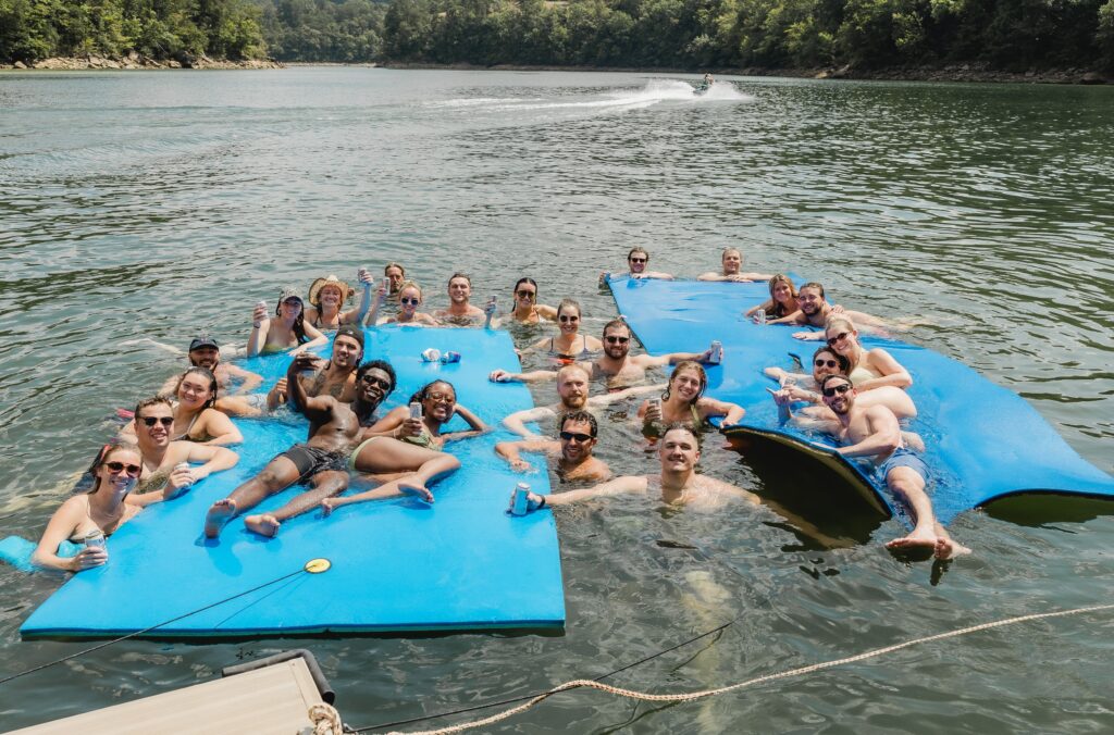 Groom and friends having fun on Smith Lake before a Barn at Smith Lake wedding