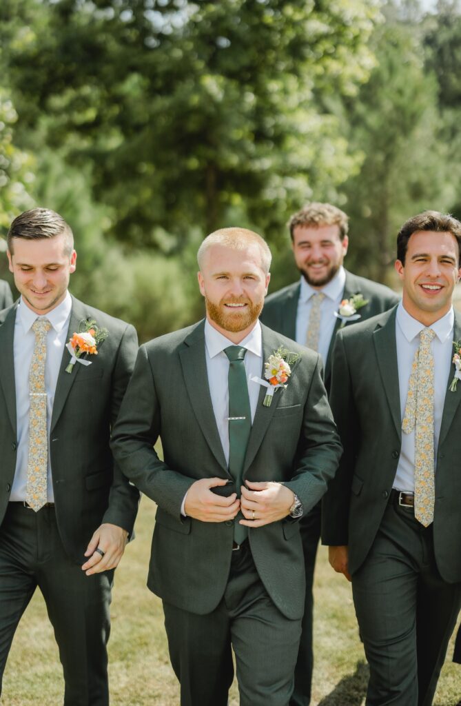 Jack with his groomsmen wearing dark green suits at The Barn at Smith Lake