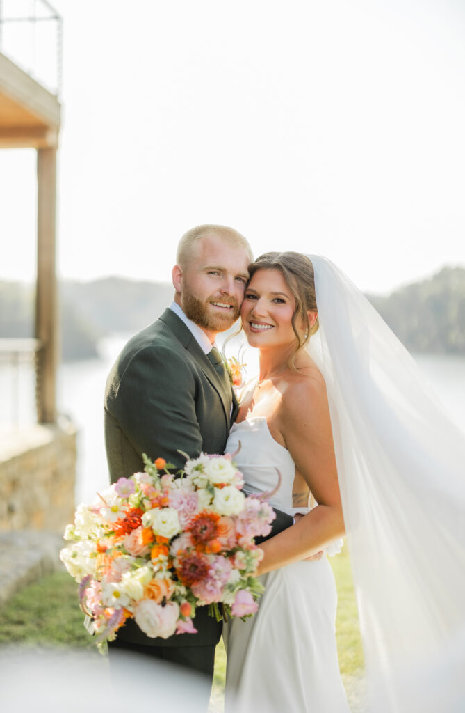 Jack and Jess enjoying their wedding portraits by Smith Lake