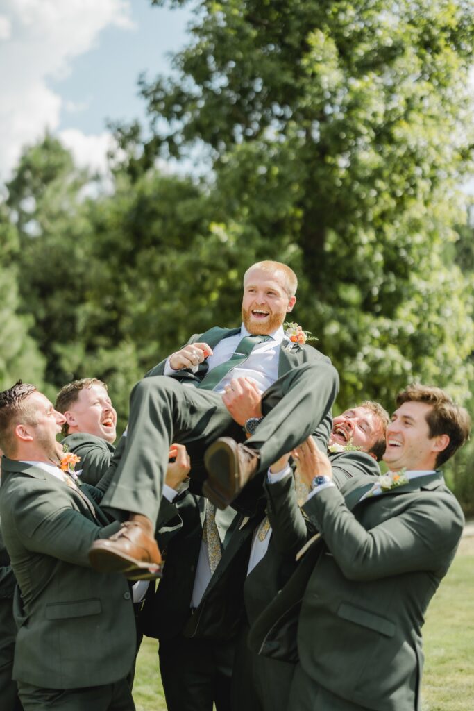Groom laughing with his groomsmen before his Smith Lake wedding