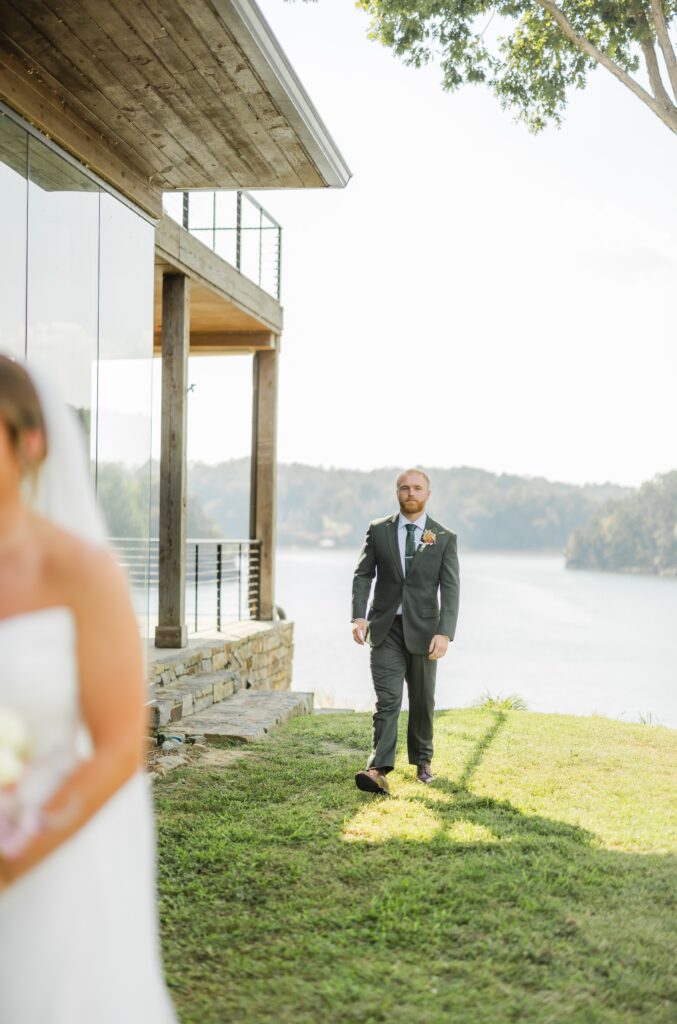 Groom walking toward his bride during a reverse first look