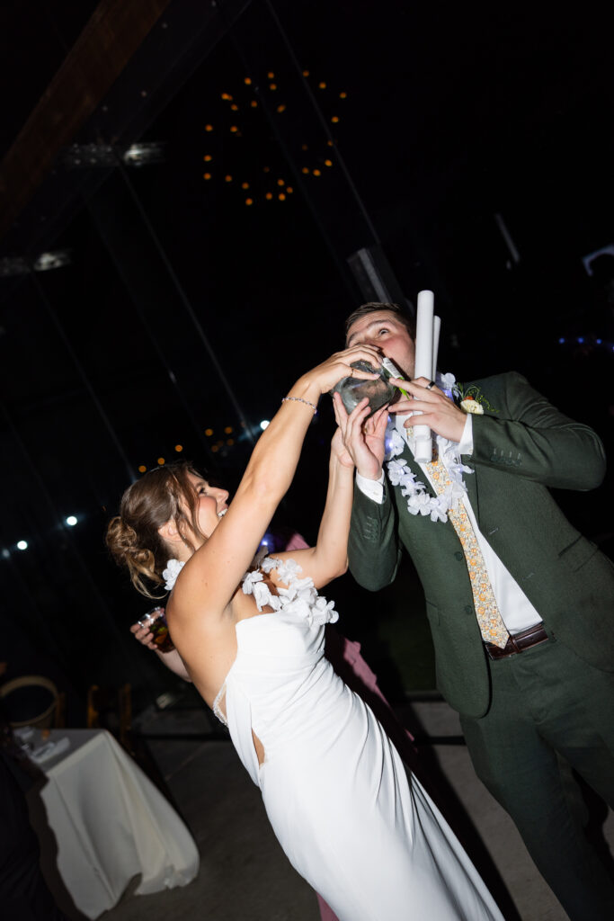 Jess's father handing out tequila bottles during the wedding reception