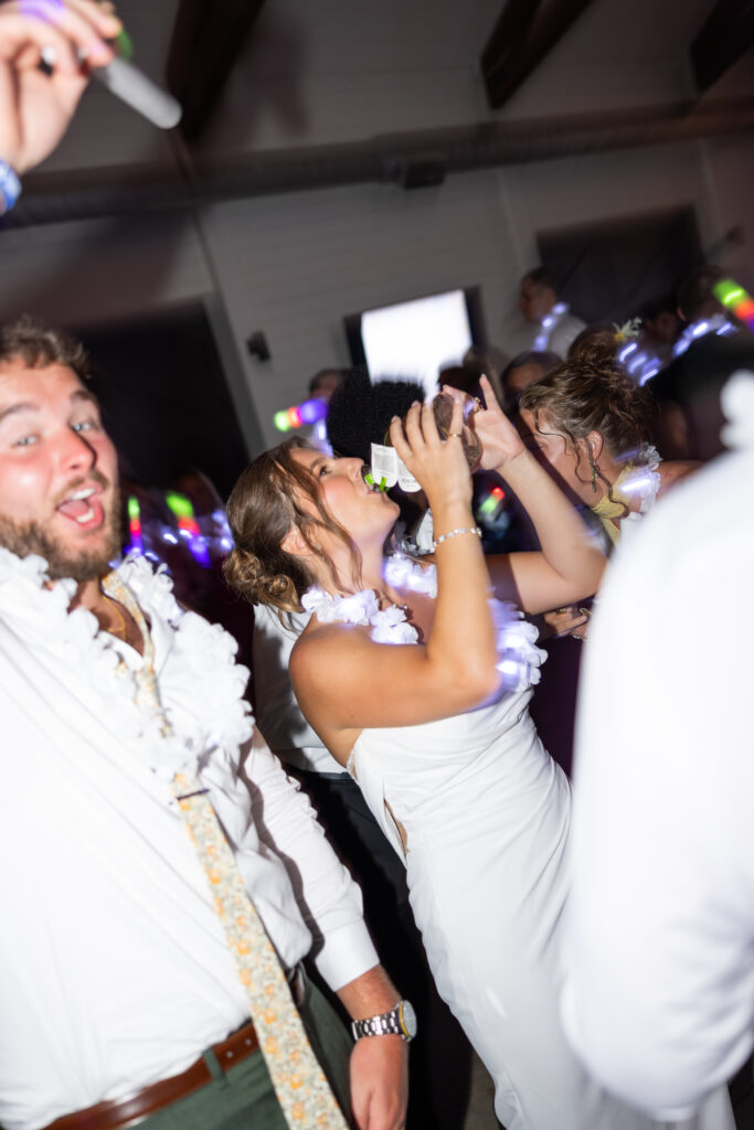 Jess's father handing out tequila bottles during the wedding reception