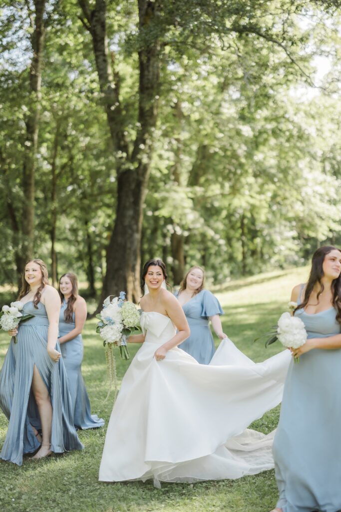 Abby’s bridesmaids walking together for a wedding-day portrait.