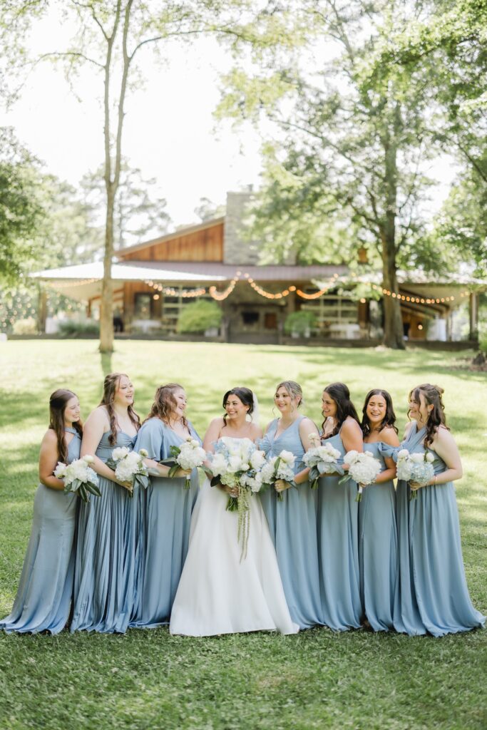 Abby’s bridesmaids laughing together for a wedding-day portrait.